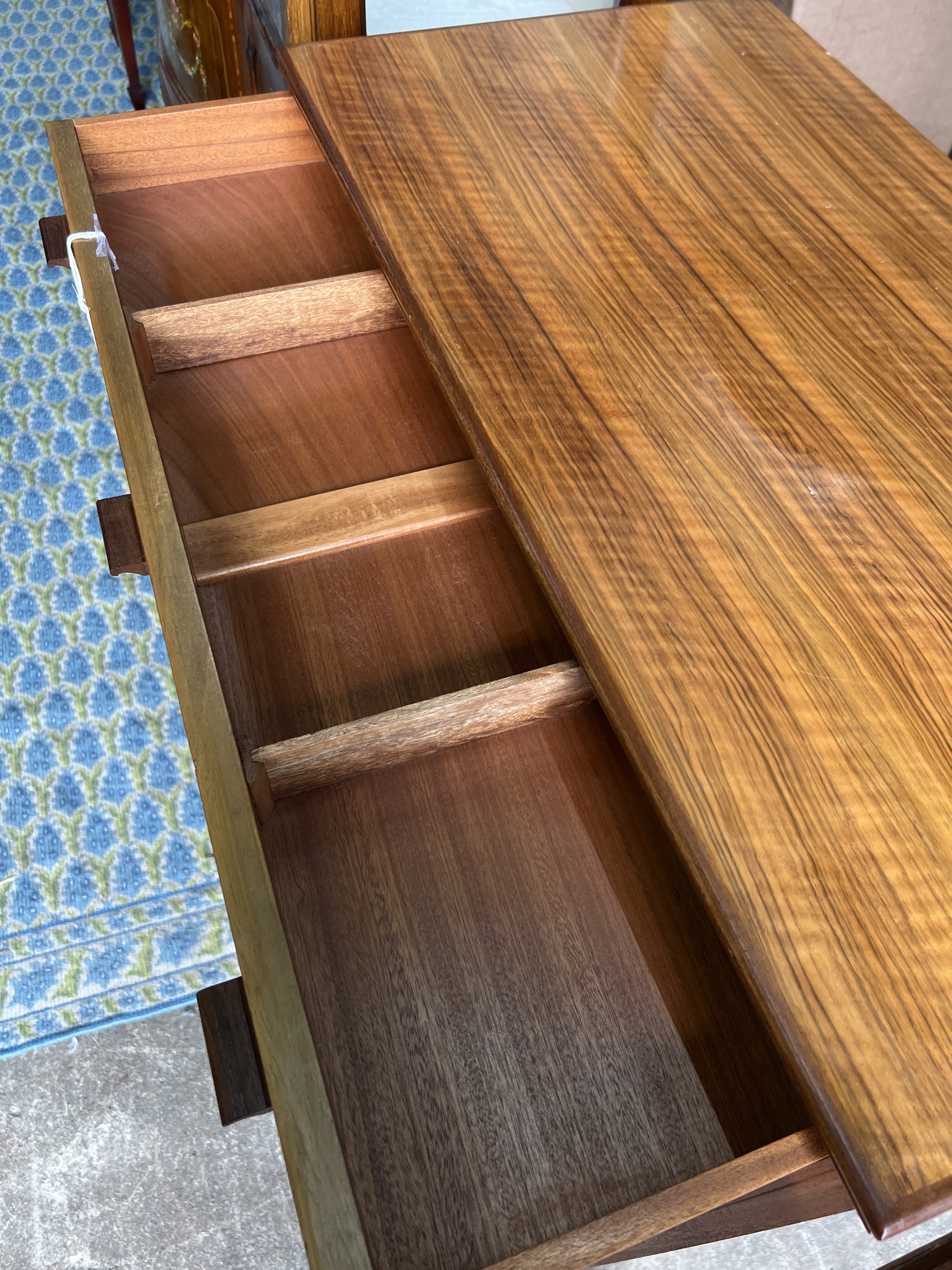 Attributed to Alfred Cox for Heals. A mid century walnut five drawer chest, width 85cm, depth 44cm, height 99cm